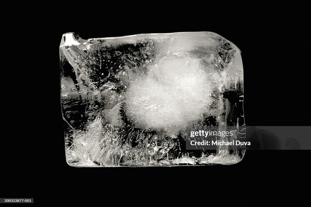 Ice cube on black background