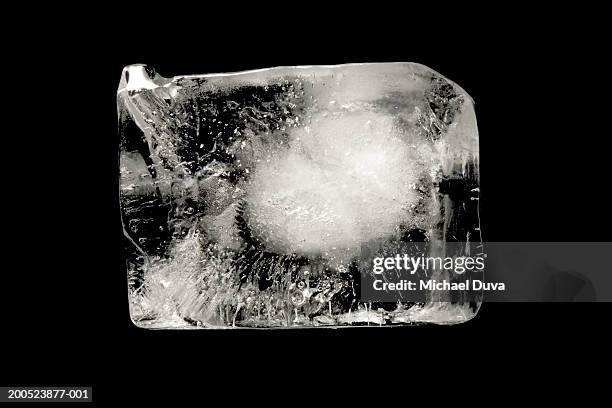 ice cube on black background - ice cube stock-fotos und bilder