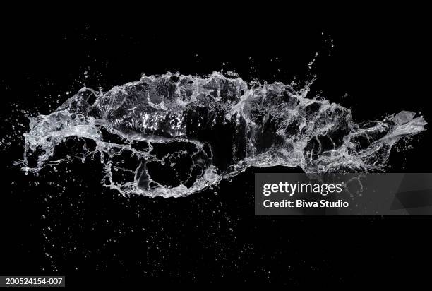 splash of water on black background - water splash imagens e fotografias de stock