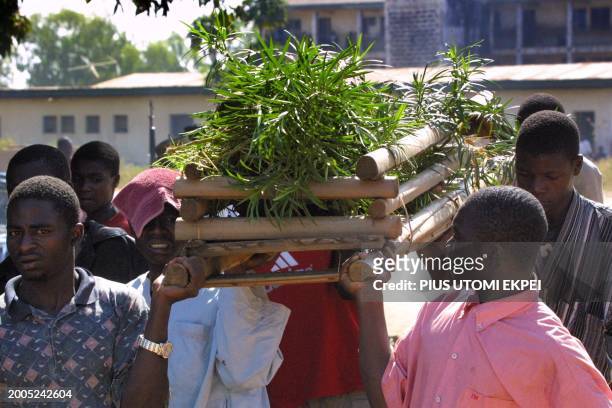 Muslim pall bearers carry a body for burial at Kabala Doki, Kaduna, 22 November 2002. More than a hundred people were feared dead in two days of...