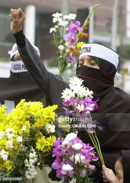 Muslim woman shouts anti-Israel slogans during a demonstration against Israel at a main street in Jakarta, 29 November 2002. More than 50 people from...