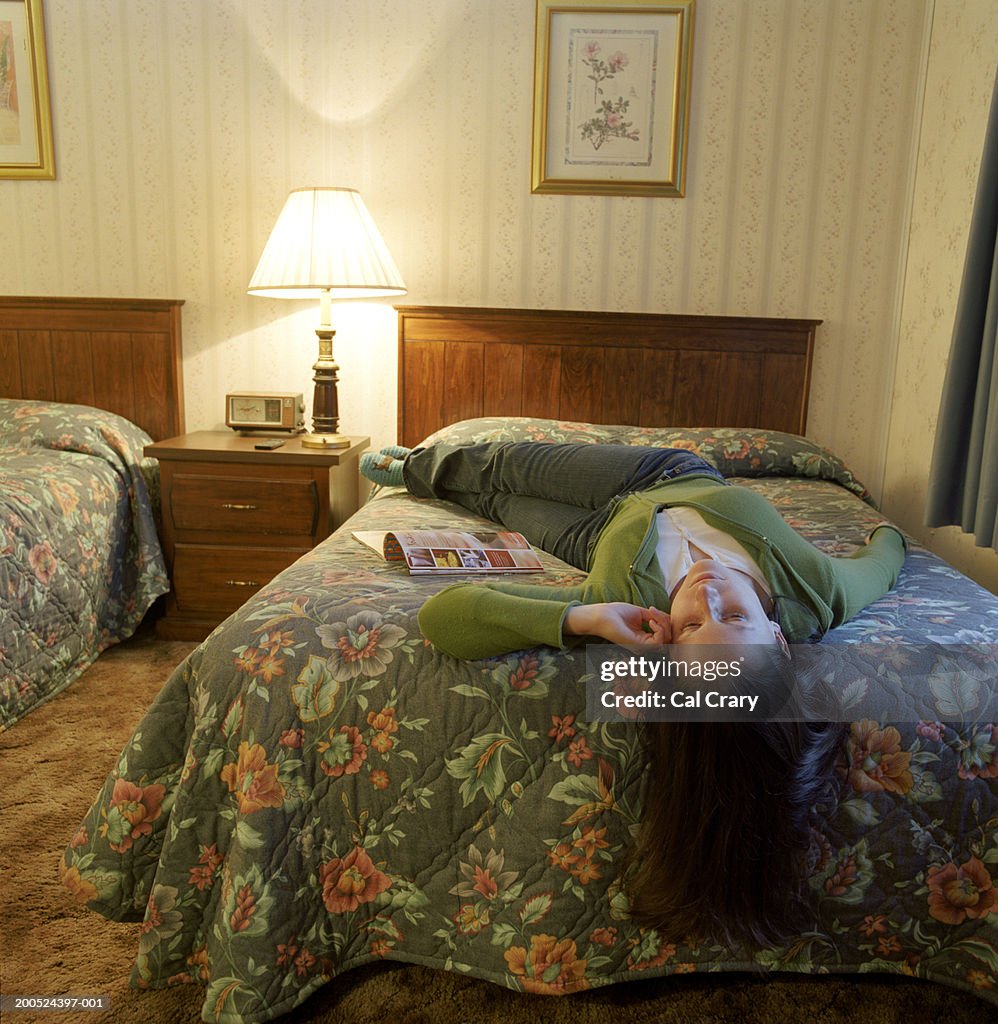 Woman lying on hotel bed