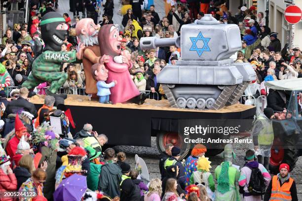 Parade float shows an effigy of a Hamas activist pushes a family in front of an Israeli tank at the annual Rose Monday Carnival parade on February...