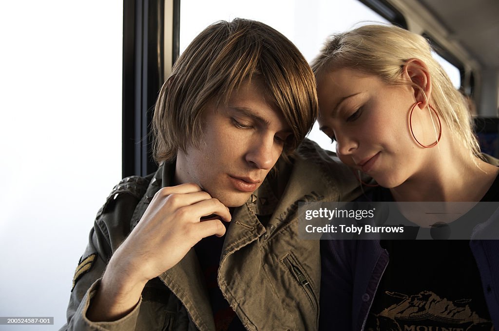 Young couple embracing on bus