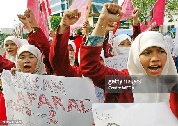 Female Muslim students raise their fists during a rally to support Muslim cleric Abu Bakar Bashir at a main street in downtown Solo, Central Java 29...