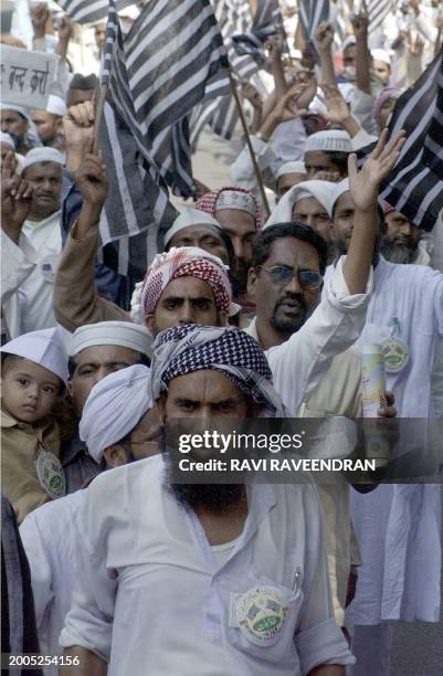 Muslim activists from the Jamiat Ulama-I-Hind forum hold placards and flags during a demonstration near Parliament in New Delhi 09 October 2002. The...