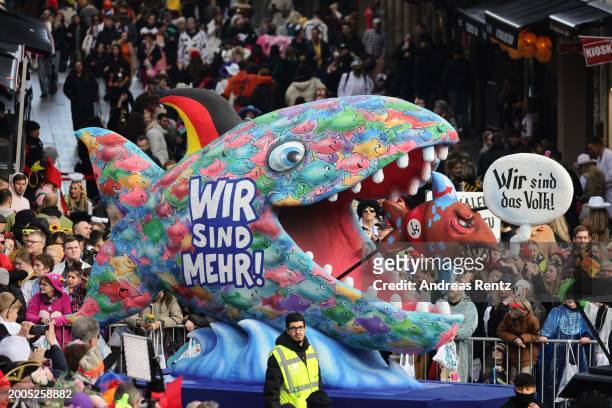 Parade float shows an effigy of a shark, that shows a slogan that reads 'We are more. We are the people' at the annual Rose Monday Carnival parade on...