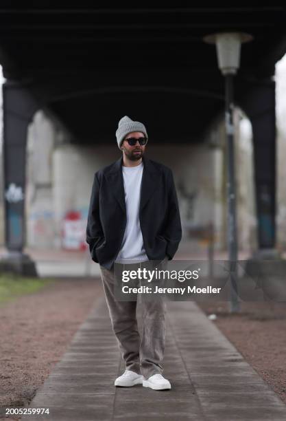 Benjamin Beyer aka David Puentez seen wearing Jacques Marie Mage black sunglasses, grey wool knit beanie hat, white cotton t-shirt, dark grey checked...