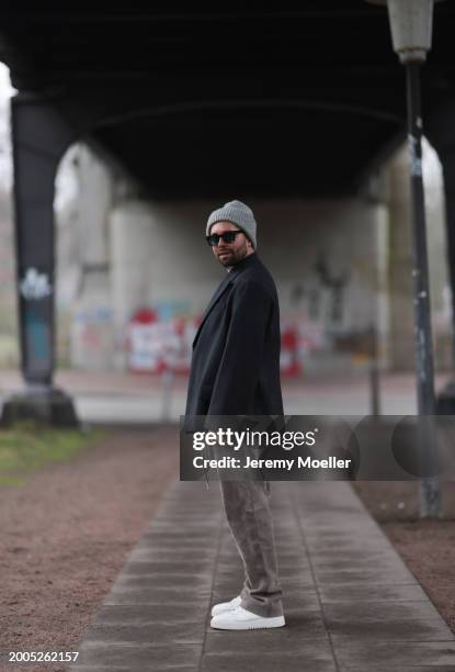 Benjamin Beyer aka David Puentez seen wearing Jacques Marie Mage black sunglasses, grey wool knit beanie hat, white cotton t-shirt, dark grey checked...