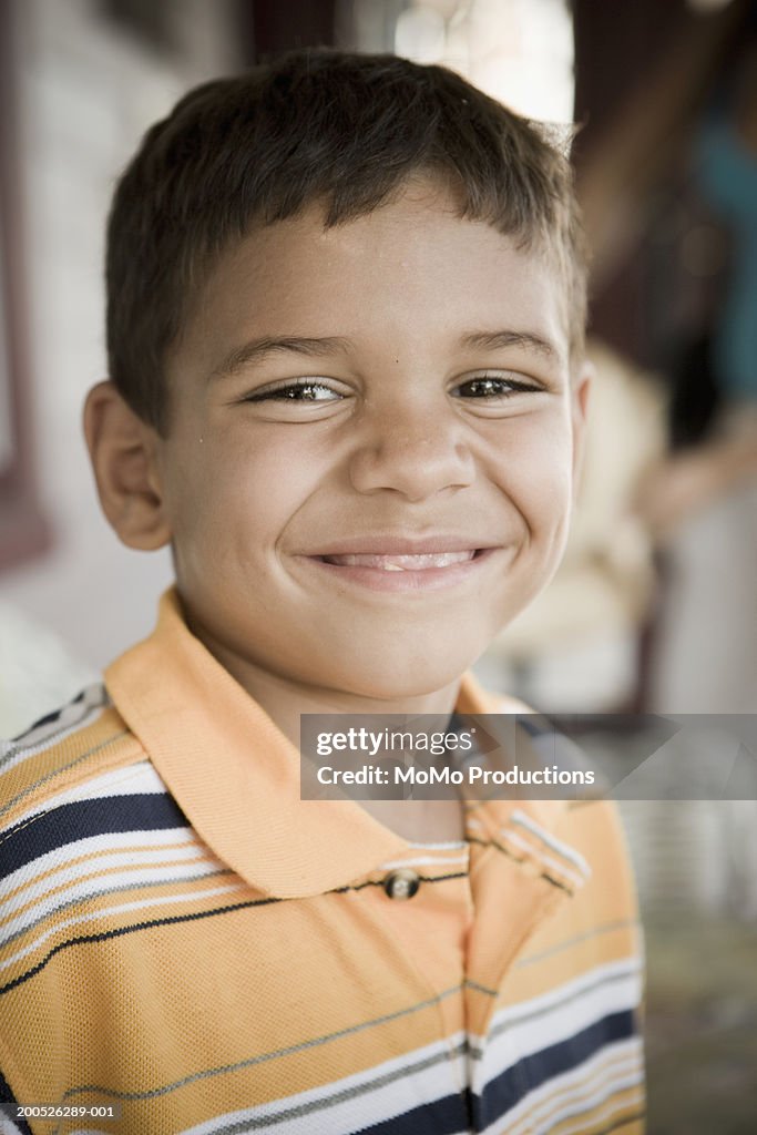 Boy (5-7) smiling, portrait