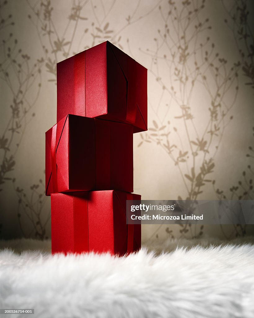 Stack of gift boxes on fur carpet, close-up, low angle view