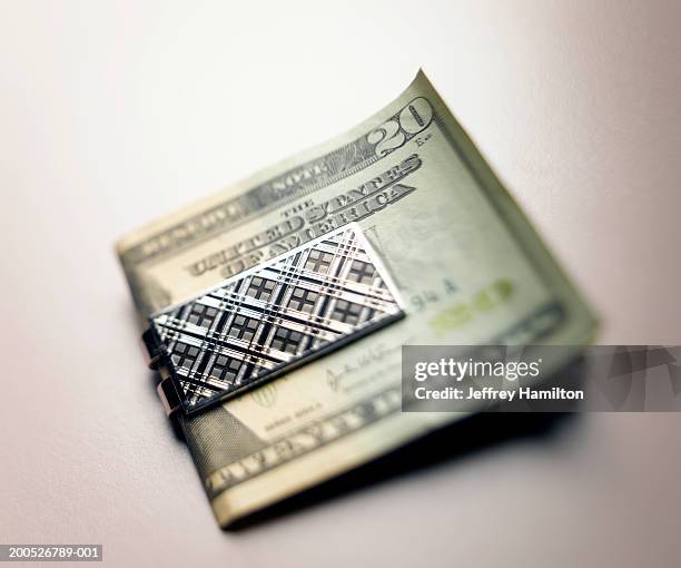 folded twenty us dollar banknotes in money clip, close-up (still life) - money clip stock pictures, royalty-free photos & images