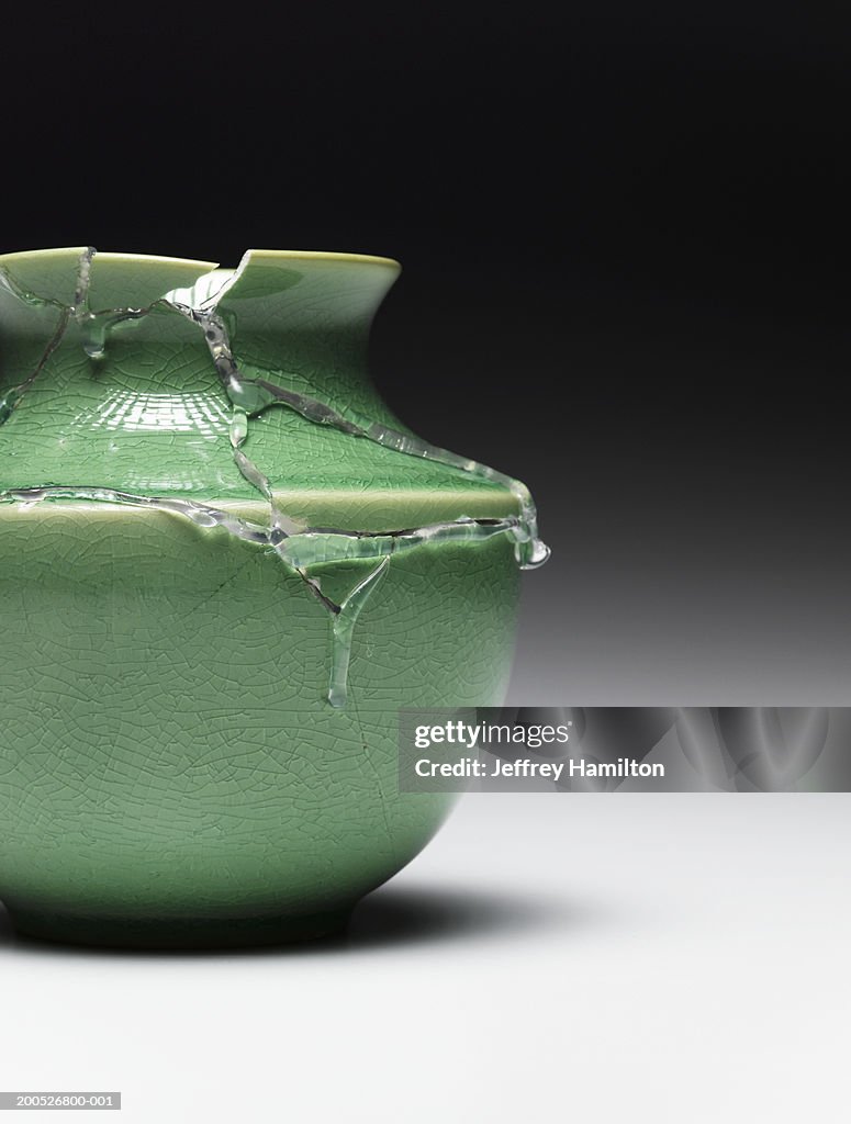 Broken green vase glued together (still life)