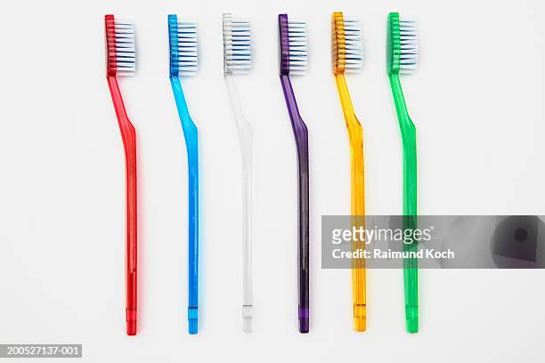 row of multi-coloured toothbrushes - toothbrush imagens e fotografias de stock