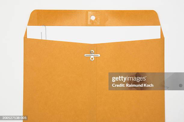 manila envelope with paper in it - paper clips on white stock pictures, royalty-free photos & images