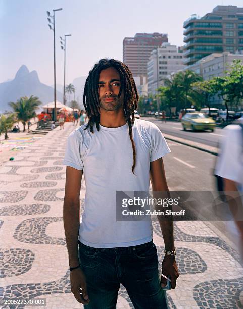 young man standing on sidewalk, portrait - ipanema promenade stock pictures, royalty-free photos & images