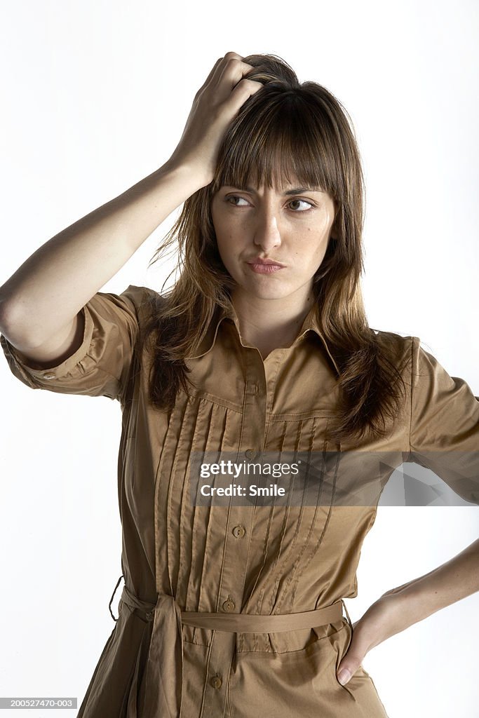 Woman scratching her head with confusion, close-up