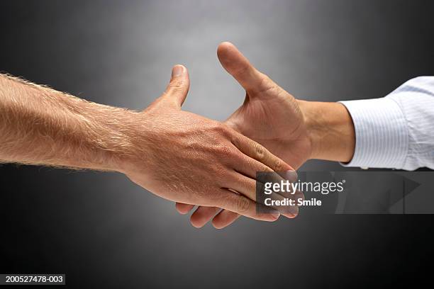 two man about to shake hands, close-up on hands - handshake closeup stock pictures, royalty-free photos & images
