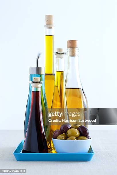 bottles of olive oils and olives - olive oil bowl stock pictures, royalty-free photos & images