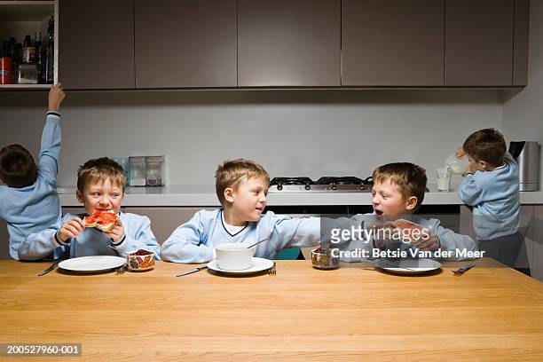 boys (8-10) arguing at the breakfast table - annoying brother stock pictures, royalty-free photos & images