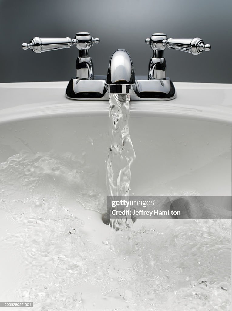 Water pouring from sink faucet
