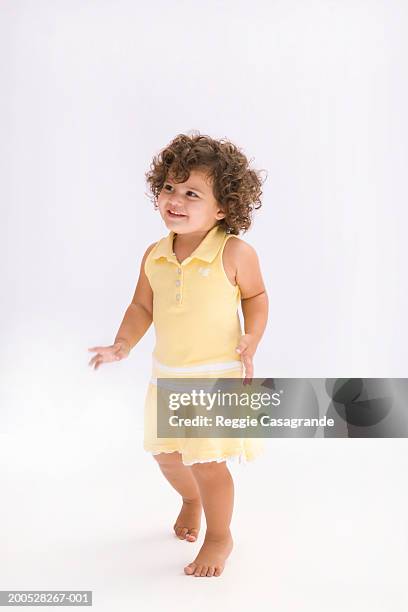 girl (21-24 months) wearing yellow dress, smiling - one baby girl only fotografías e imágenes de stock