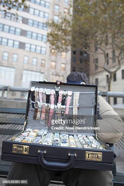 man holding briefcase of watches on street - dörrförsäljare bildbanksfoton och bilder