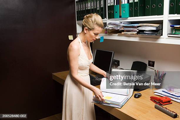 woman in evening dress reading through file - paper gown stock pictures, royalty-free photos & images