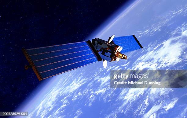 communication satellite over the earth - satellite space fotografías e imágenes de stock