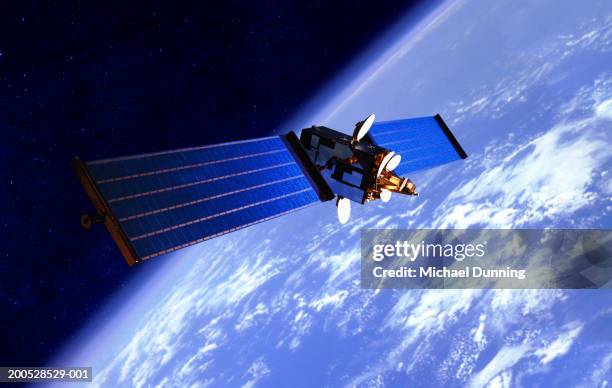 communication satellite over the earth - space foto e immagini stock