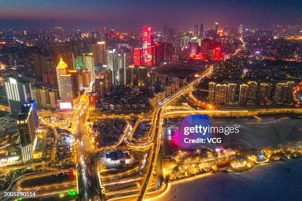 Aerial view of the night streets illuminated by colorful lights across the city on the second day of the Chinese New Year on February 11, 2024 in...