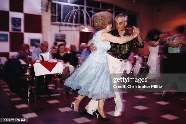 Dec 1995, blurred motion. Argentina, Buenos Aires, senior couple dancing at club.