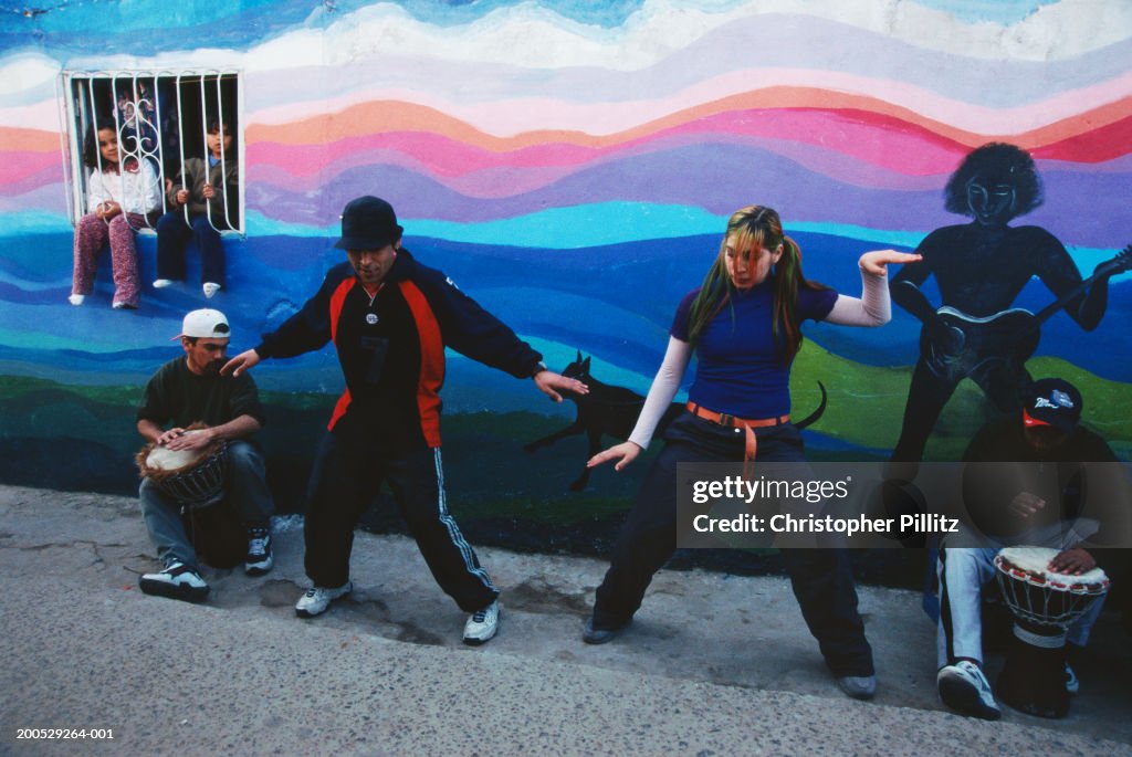 Argentina, Buenos Aires, youths dancing to drums in street...