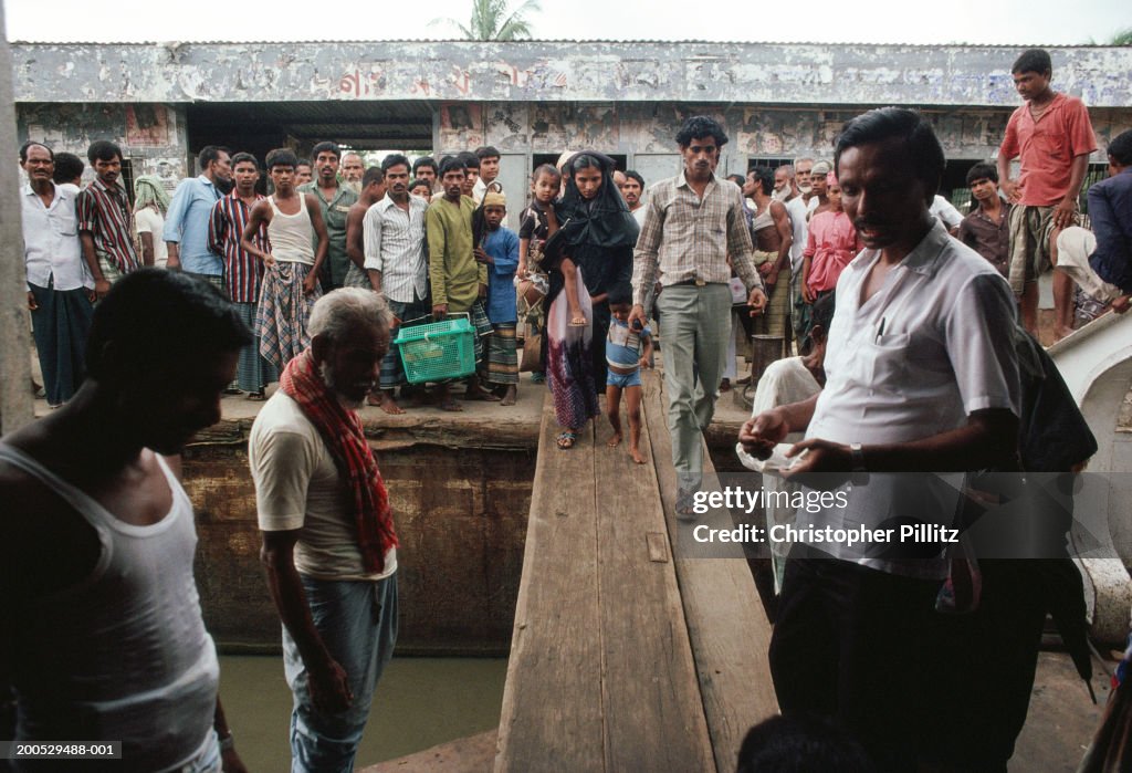 India, Bangladesh, people boarding river boat...