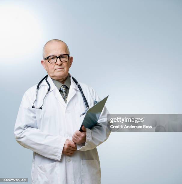 senior male doctor holding clipboard, portrait - clipboard and glasses stock pictures, royalty-free photos & images