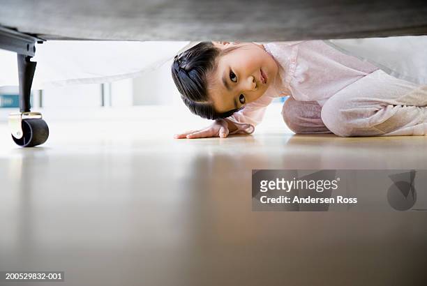 girl (3-5) looking under bed, ground view - below stock pictures, royalty-free photos & images