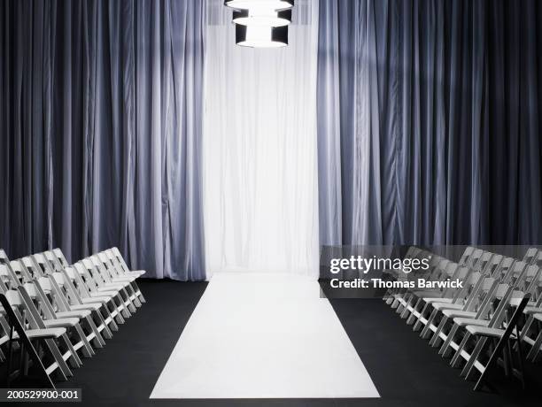 rows of chairs beside catwalk - runway stock-fotos und bilder