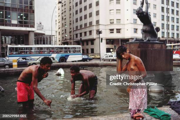 Brazil, Rio de Janeiro, homeless boys bathing in fountain.