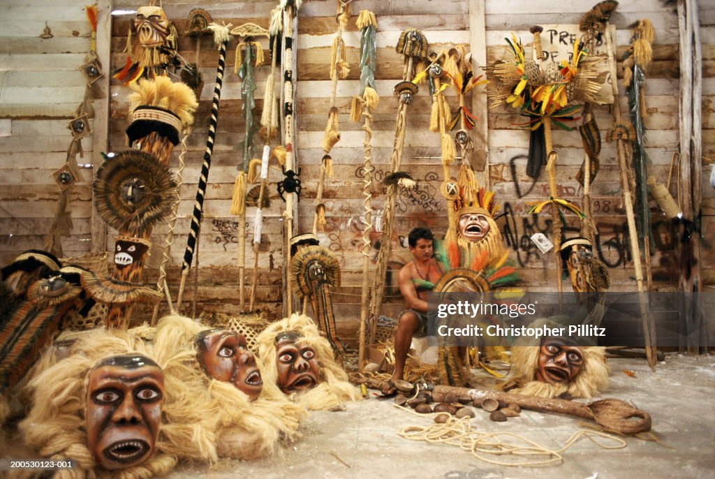A costume maker puts the finishing touches on Indian head dress for the Boi Bumba carnival celebrations, Parintins, Brazil...