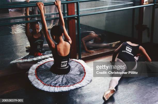 Mar 2004, project for children from favela. Brazil, Rio de Janeiro, girls stretching in ballet class.