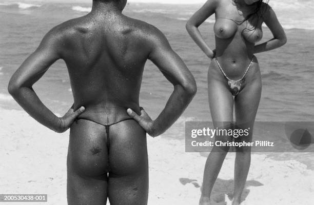 Feb 1993, Barra de Tijuca. Brazil, Rio de Janeiro, partially clothed man and woman on beach .