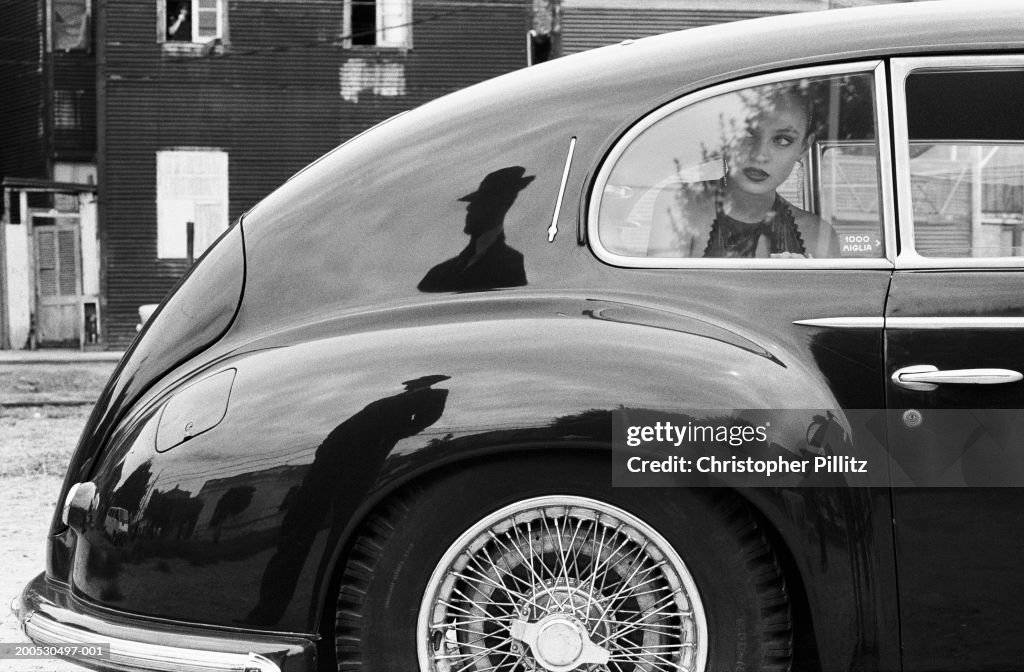 Argentina, woman looking out of car window (B&W)