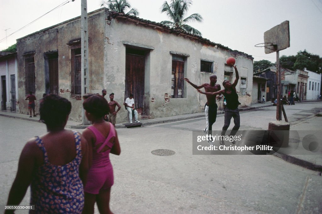 Cuba, Santiago de Cuba, boys playing basketball in street...