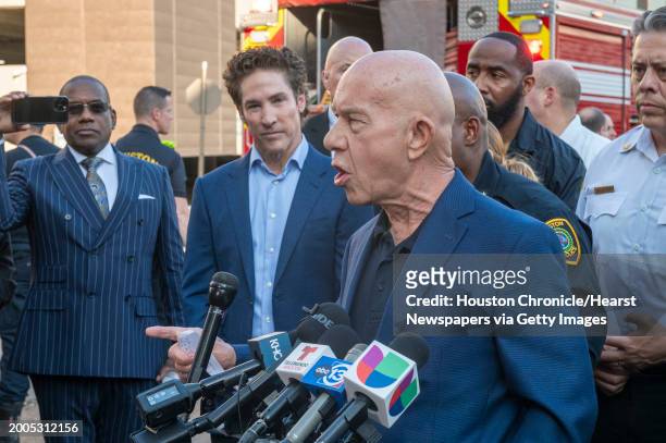 Lakewood Church pastor Joel Osteen, left center, listens as Mayor John Whitmire comments during a press conference during an active shooter event at...