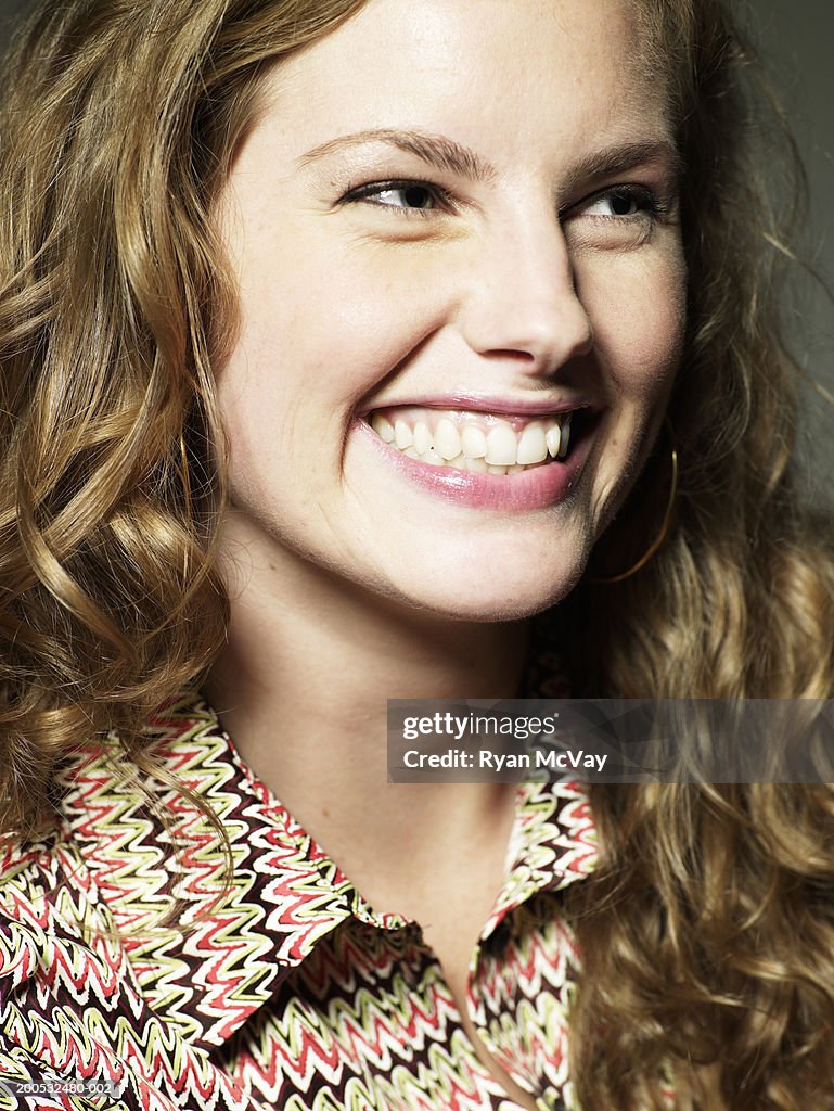 Young woman smiling, looking away