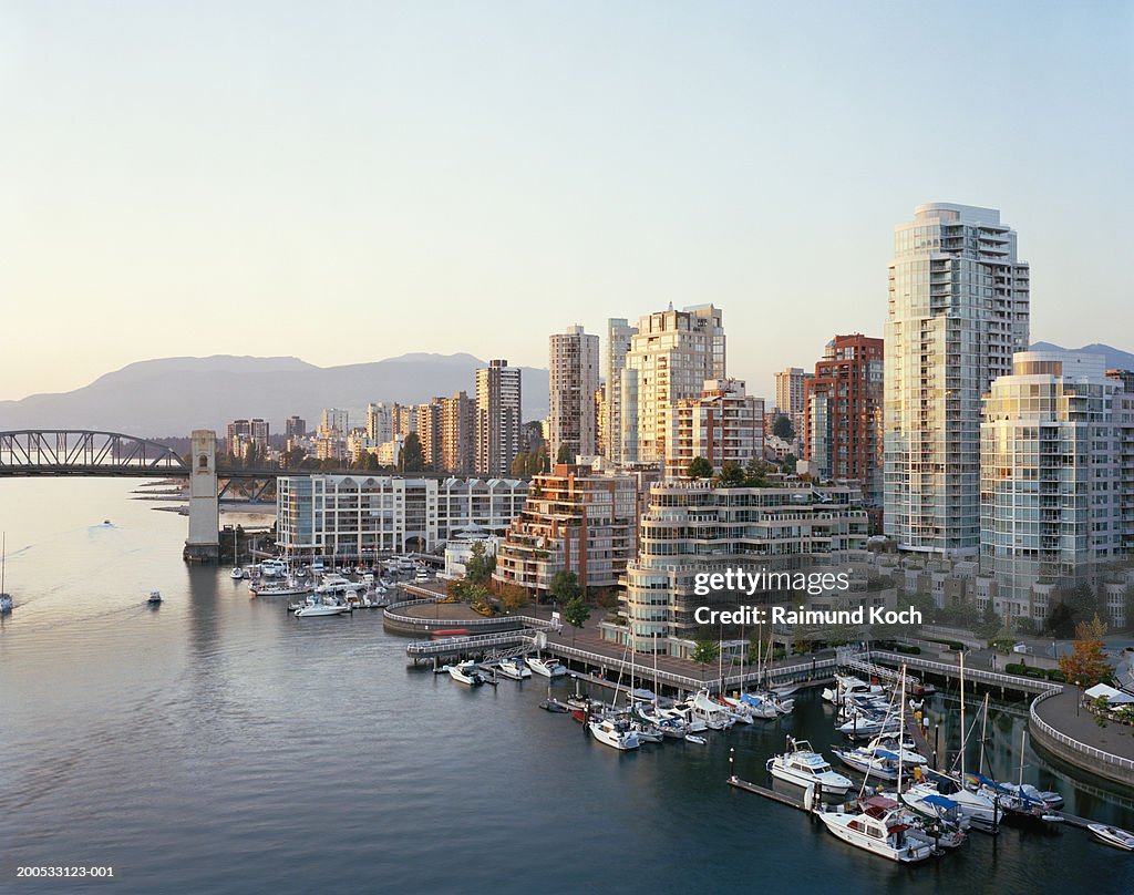 Canada, British Columbia, Vancouver, yachts moored in marina, city skyline in background