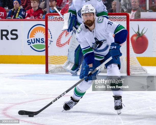 Filip Hronek of the Vancouver Canucks controls the puck against the Detroit Red Wings during the first period at Little Caesars Arena on February 10,...