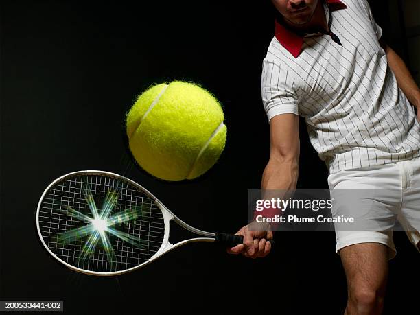 young man playing tennis, mid section, (digital composite) - bola de tenis fotografías e imágenes de stock