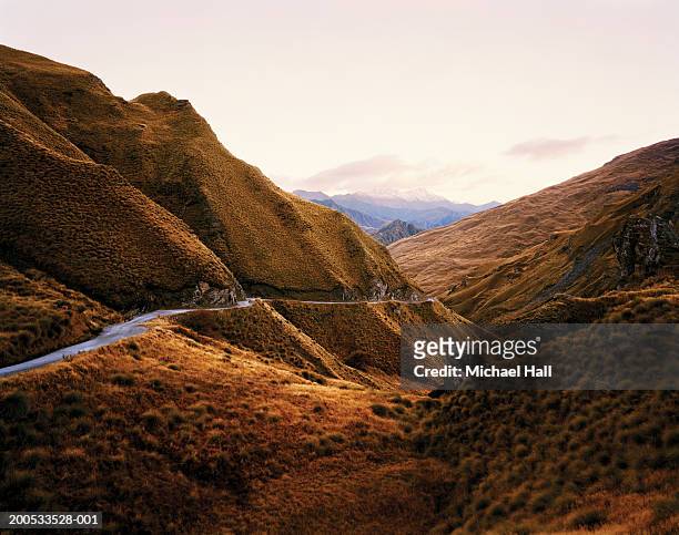 new zealand, otago, skippers canyon, road in mountainous landscape - otago stock pictures, royalty-free photos & images