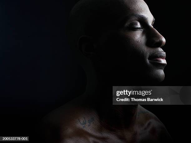 young man with eyes closed - concentration face and male and side stock pictures, royalty-free photos & images